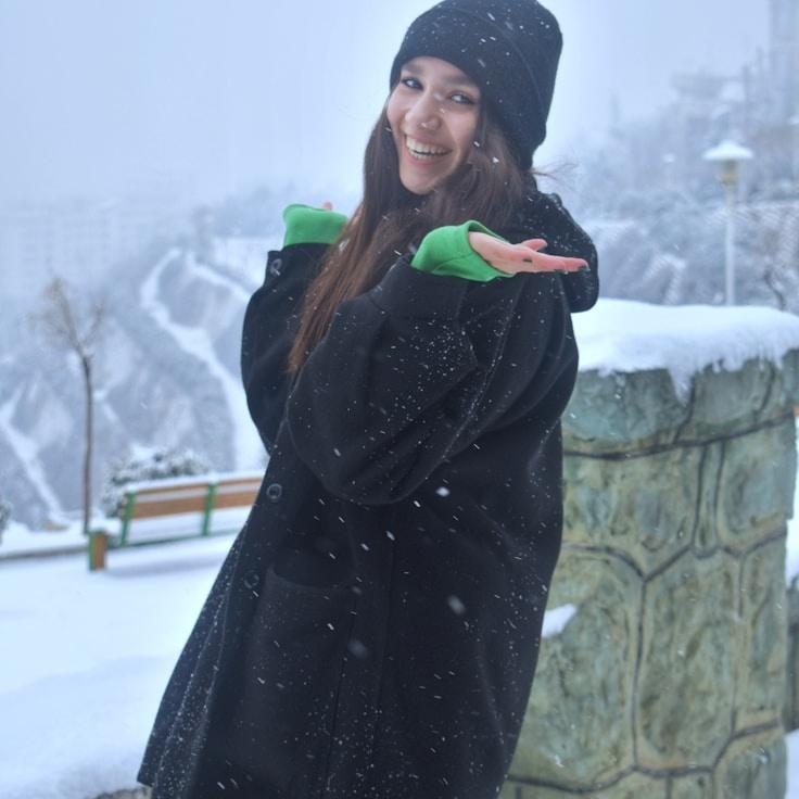 Kaveri Mehta, Lead Design Curator at BrookHarborPlum, reviewing corporate floral arrangements